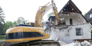 excavator demoing house 1200x600 1